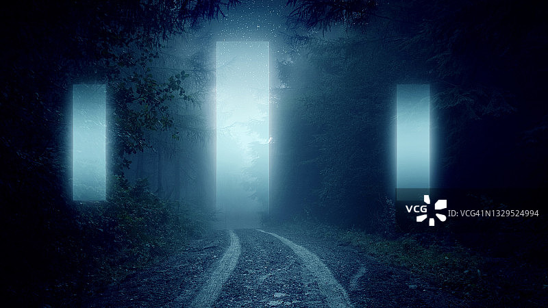 迷雾笼罩的阴森冬夜森林中发光的传送门图片素材