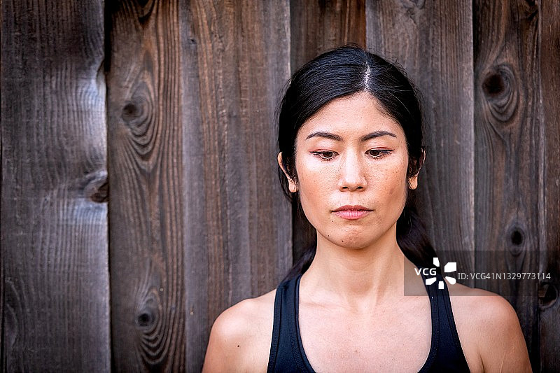 沉思美丽的亚洲中年女性，目光向下图片素材