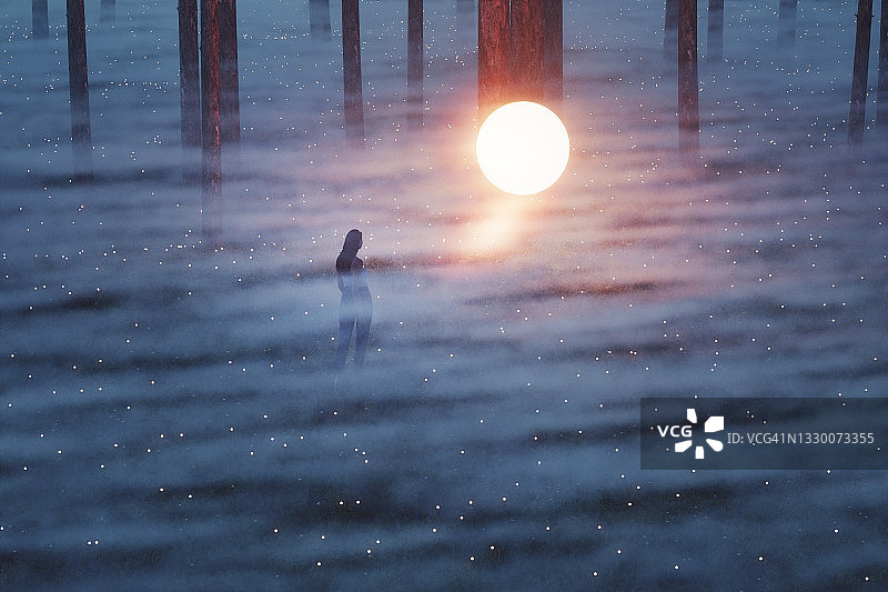 夜晚森林中拿着神秘发光球体的女人图片素材