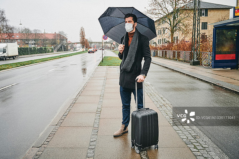 在公交车站等候的年轻男人图片素材