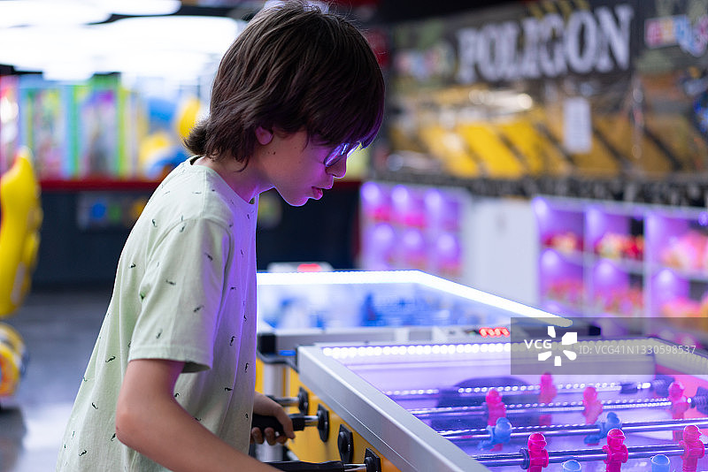 快乐的男孩在游乐园一起玩桌上足球图片素材