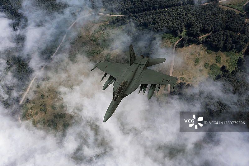 喷气式战斗机在云层上飞行。图片素材