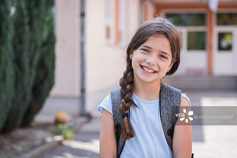 面带微笑的女学生，在校园里手上贴着创可贴图片素材