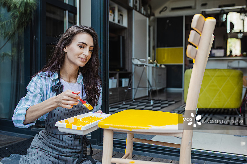 在后院粉刷木椅图片素材