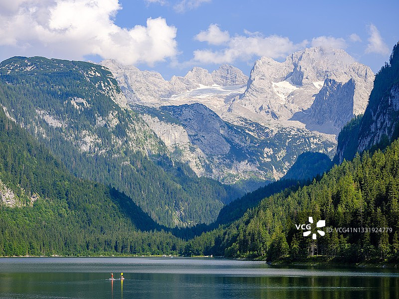 戈绍湖上的桨板冲浪者，远眺达赫施泰因山和戈绍冰川（奥地利上奥地利州萨尔茨卡默古特）图片素材