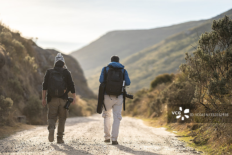 在冬季的自然小径上行走的男人们图片素材