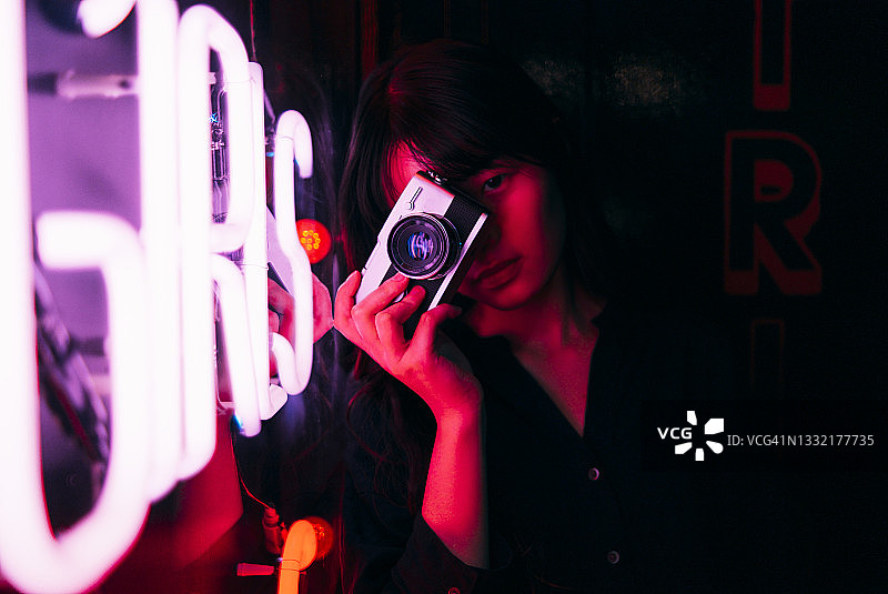 年轻女性摄影师拍摄发光文字图片素材
