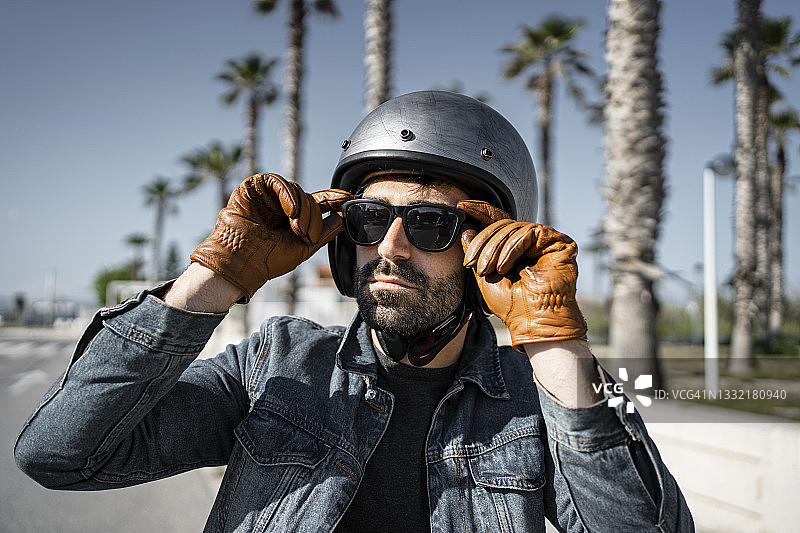 阳光明媚的日子里戴头盔和太阳镜的男人图片素材