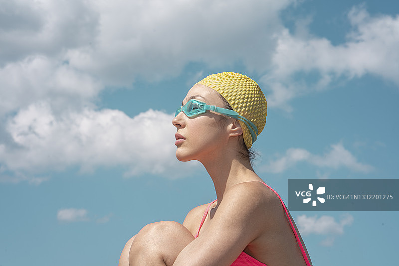 沉思的女人在阳光下抱膝图片素材