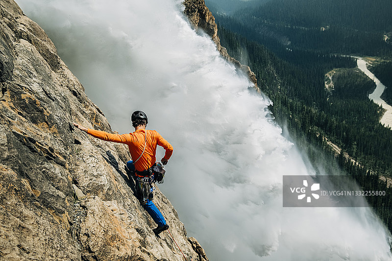 在塔卡卡瀑布旁攀岩的男性攀岩者图片素材