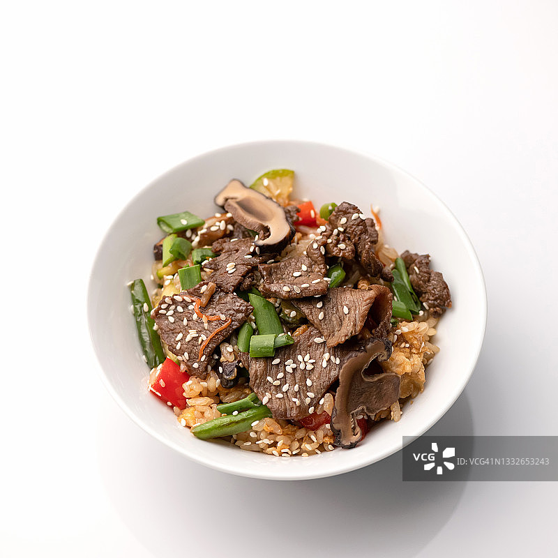 深色肉类、香草、蘑菇和芝麻炖饭（白色背景）。亚洲美食。泛亚美食。柔焦图片素材