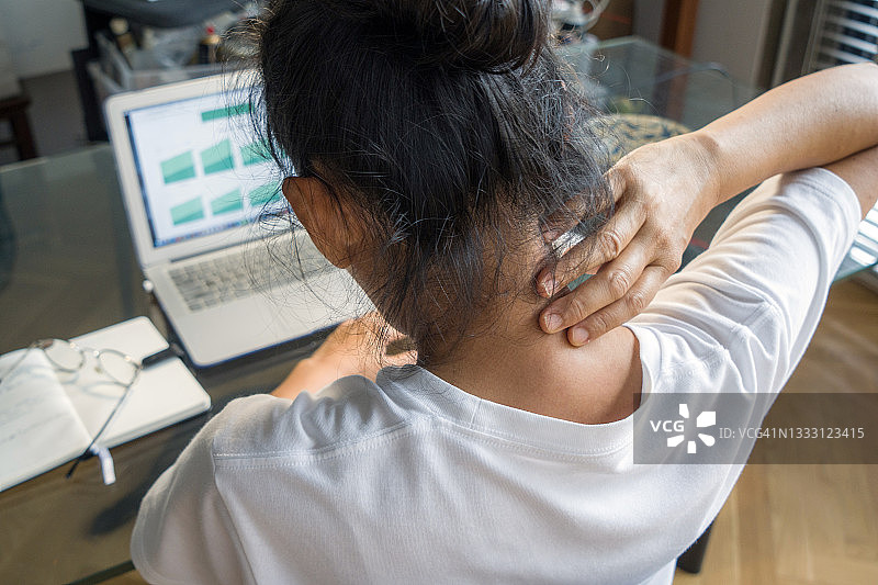 在家工作时脖子不适的女人图片素材