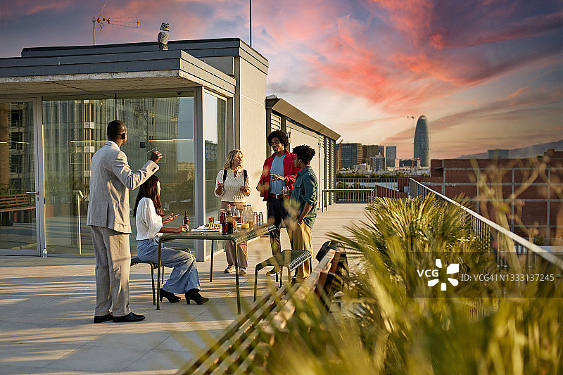办公室职员在屋顶平台上享用饮品和小吃图片素材