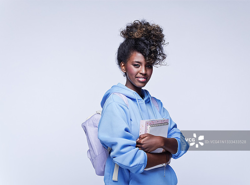 友好的穿着蓝色连帽衫的女学生图片素材