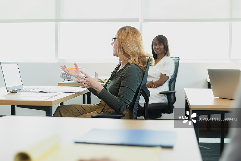 中年妇女提问，做手势图片素材
