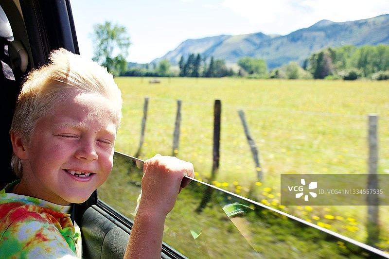 带儿童的汽车旅行——乘客在车窗外看图片素材