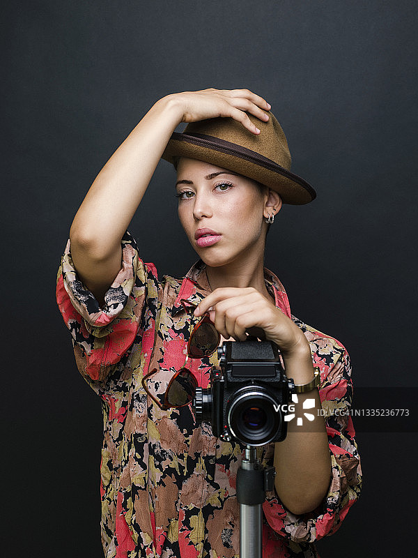 年轻漂亮女人手持中画幅胶片相机拍摄的写真图片素材