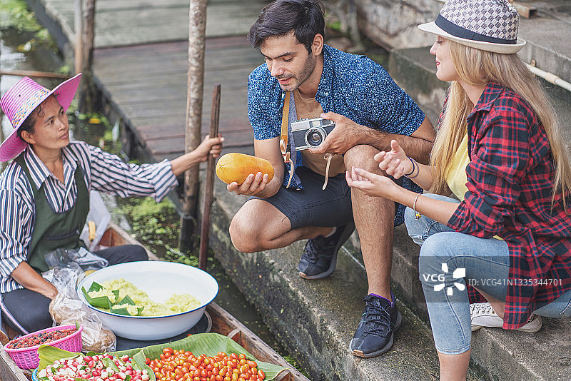 旅行者用旧相机在泰国水上市场拍照图片素材