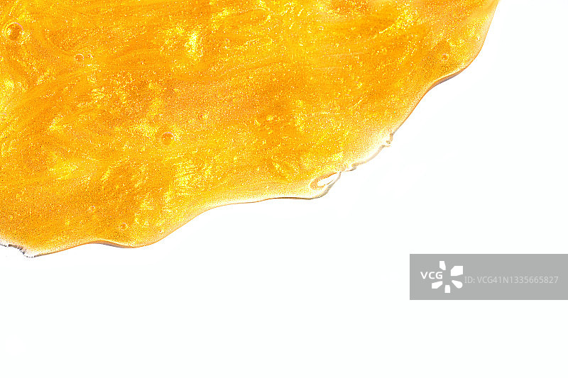 橙色美容产品（面霜或发膜）的光泽质地图片素材