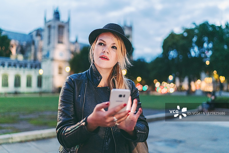 夜晚在伦敦等出租车的女人图片素材
