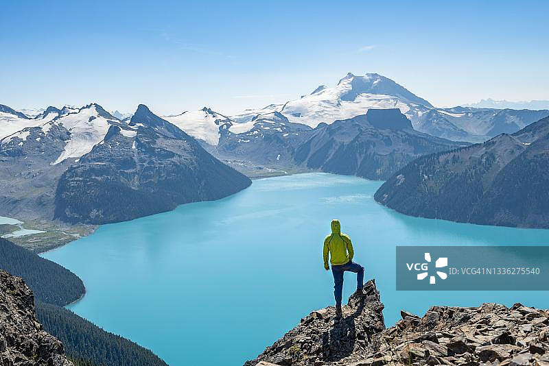 年轻男子眺望不列颠哥伦比亚省加里波第湖的冰川山景图片素材