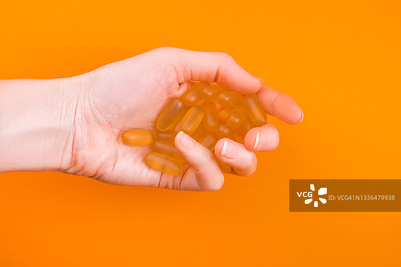 明亮背景中女性手中的药丸图片素材