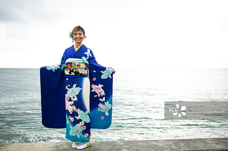 身穿和服的年轻日本女子，背景为海洋图片素材