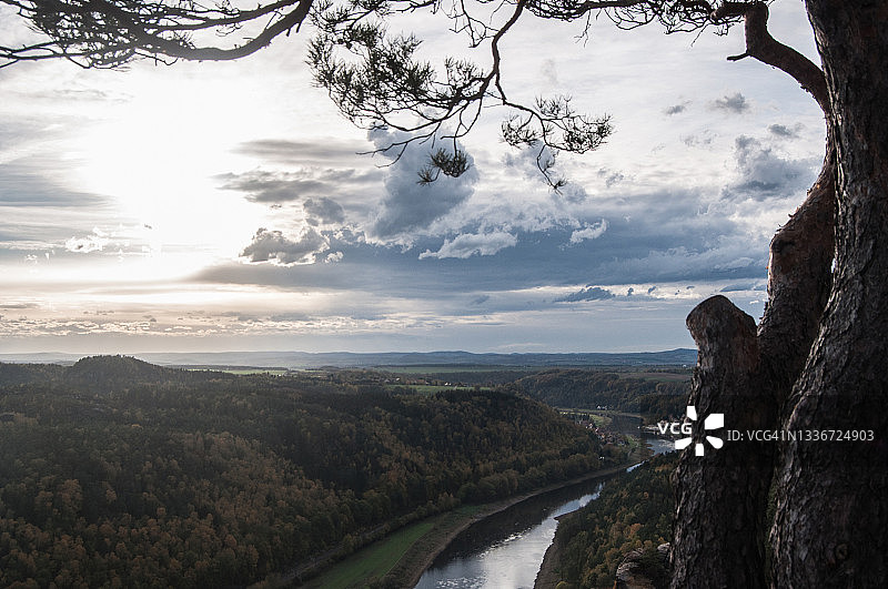 群山环绕下的宽阔河流与壮丽日落图片素材