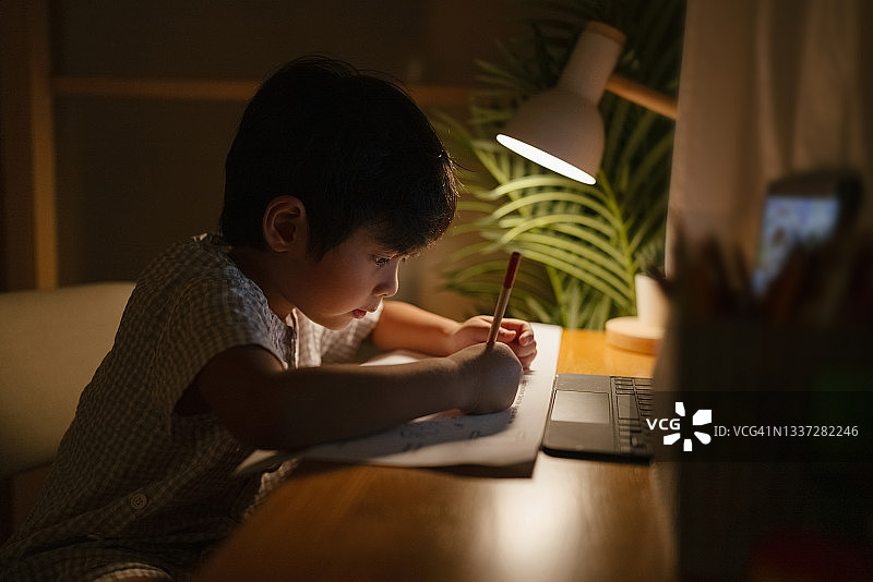 男孩晚上用数位板做作业图片素材