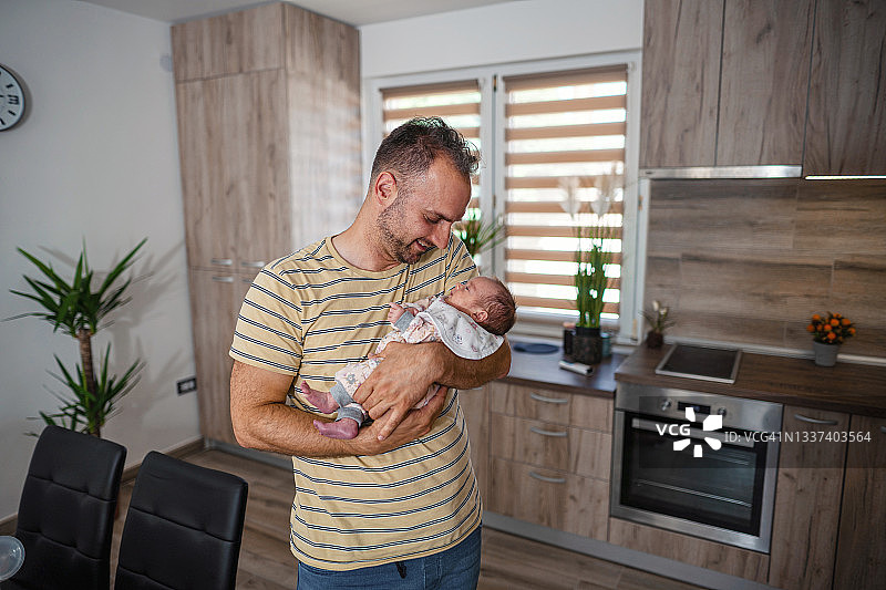 父亲在家工作时照顾宝宝图片素材