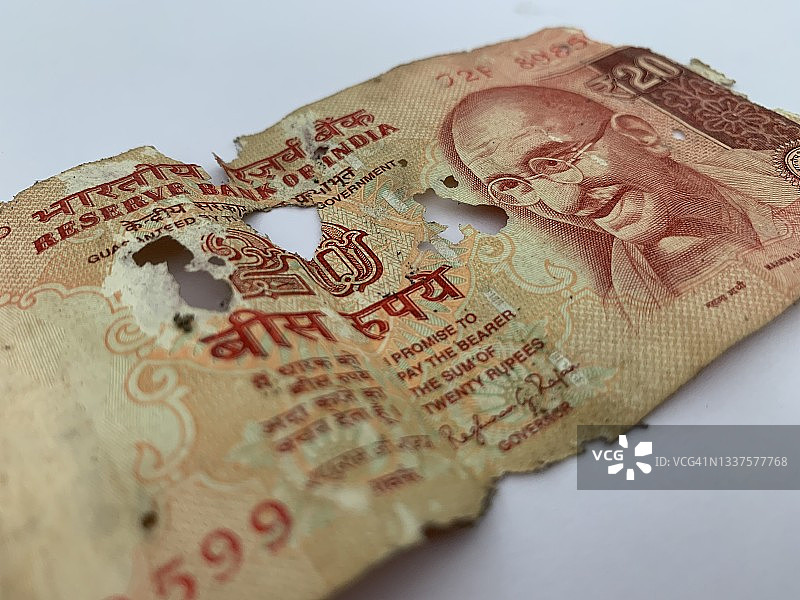 撕裂的20印度卢比纸币图片素材