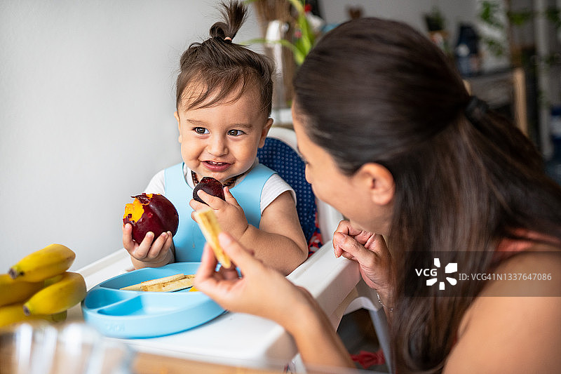 吃水果的可爱幼儿和他的妈妈图片素材