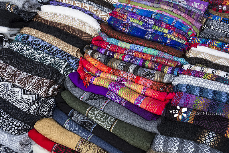 秘鲁圣谷路边摊贩出售的传统盖丘亚图案编织布图片素材