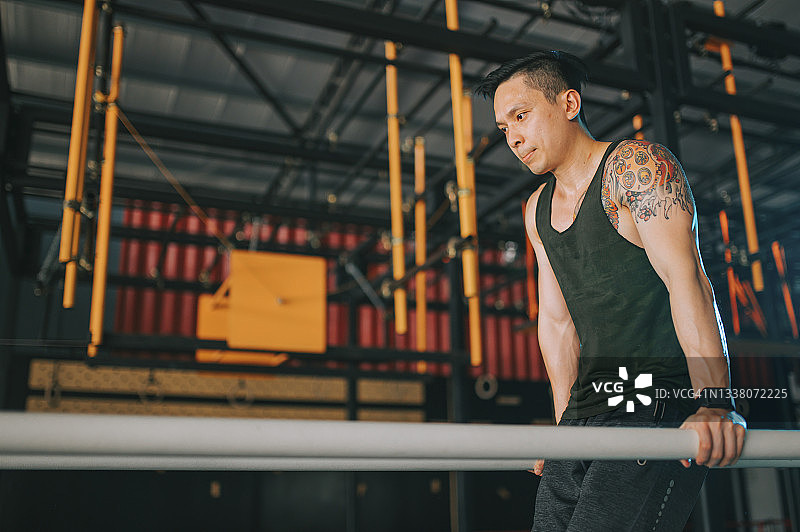极限运动：亚洲中国健壮男子运动员在健身房练习体操图片素材
