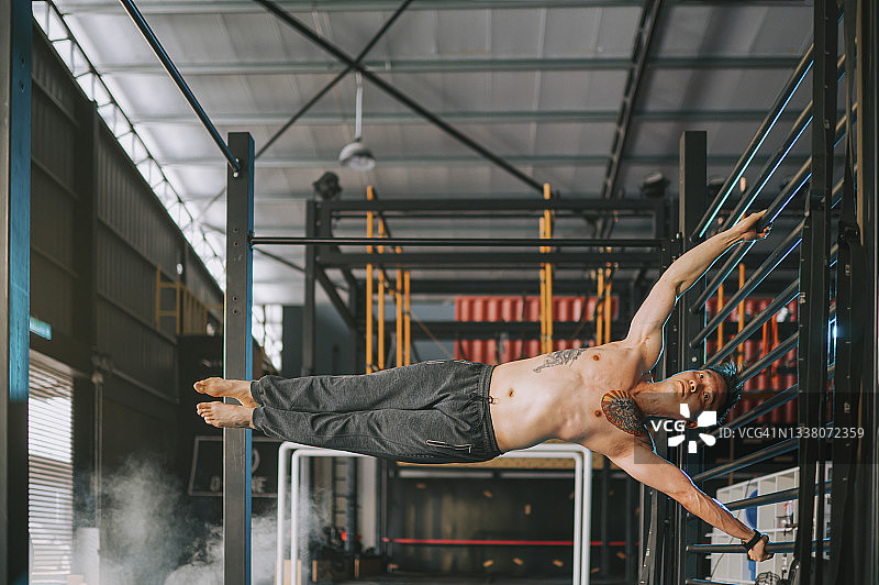 在健身房练习体操的亚洲男子图片素材