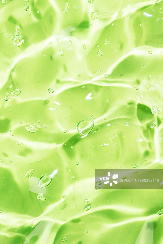 含气泡的抗菌芦荟凝胶，透明绿色液体保湿精华液，补水玻尿酸，护肤化妆品，美容，竖版图片素材