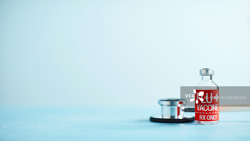 蓝色背景流感疫苗听诊器医学背景图片素材
