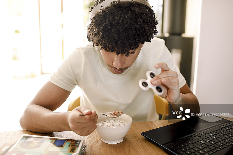 男青少年在客厅餐桌旁吃饭图片素材