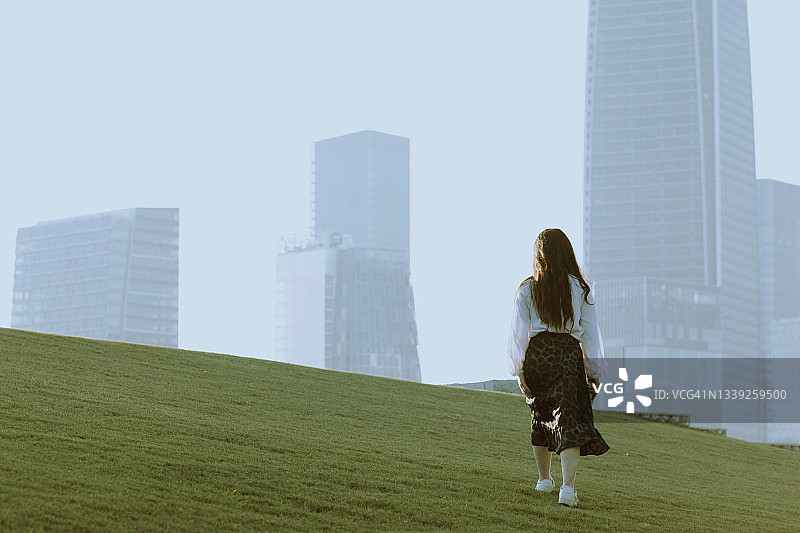 年轻女商人走向金融区的背影图片素材
