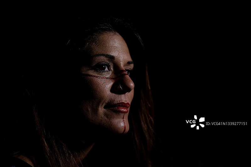 脸上画着战士油彩的严肃的女子面孔图片素材