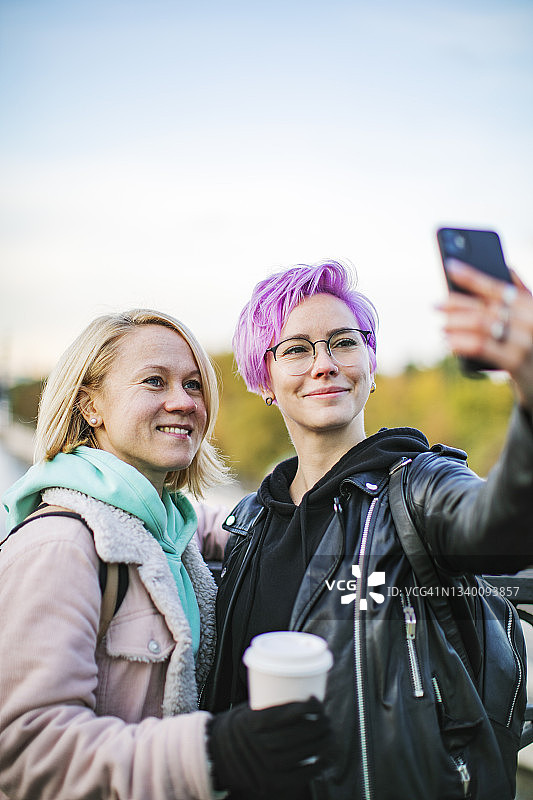 朋友们在阳光明媚的秋日户外自拍图片素材