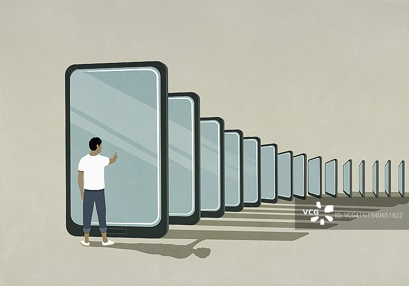 男人站在智能手机多米诺骨牌旁图片素材