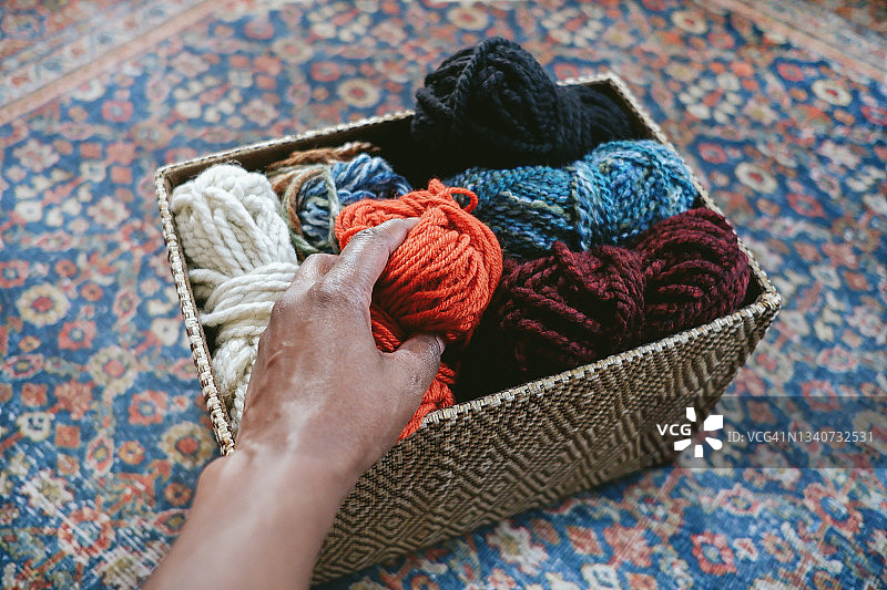 女人从纱线篮子里选择纱线图片素材