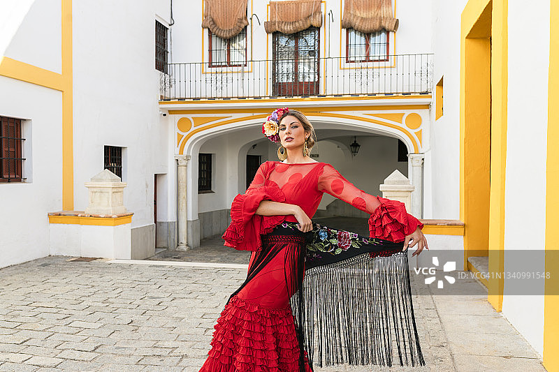 站在西班牙塞维利亚皇家骑兵斗牛广场前的女子舞蹈演员图片素材