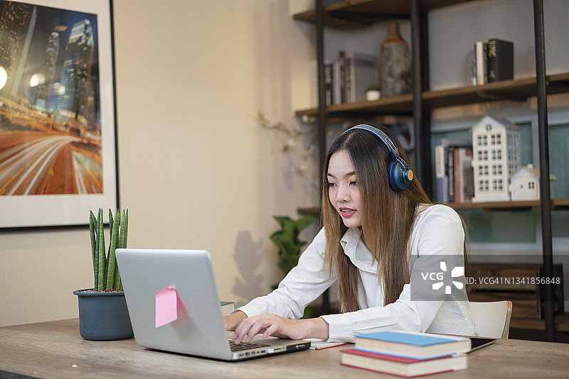 女学生使用笔记本电脑打字图片素材