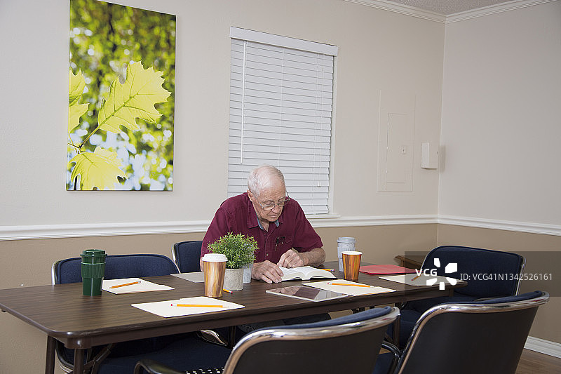 穿着休闲的老年男人在会议室里等待参加圣经学习图片素材