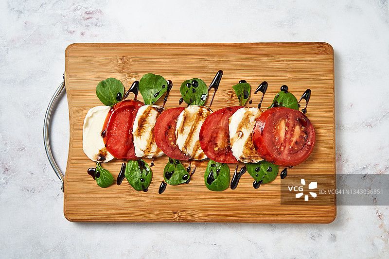 木板上的番茄与马苏里拉奶酪卡普雷塞沙拉图片素材