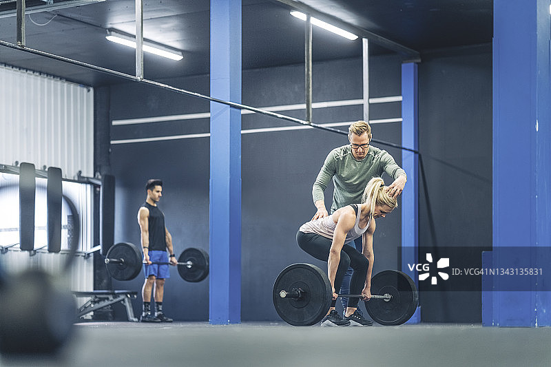 男教练指导女运动员正确姿势图片素材