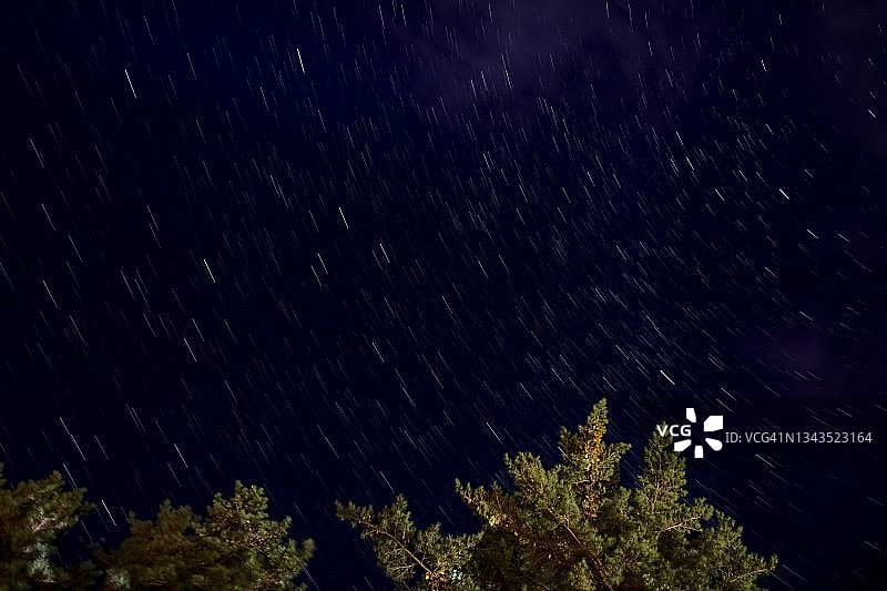 日本山梨县森林树梢之上的星迹图片素材