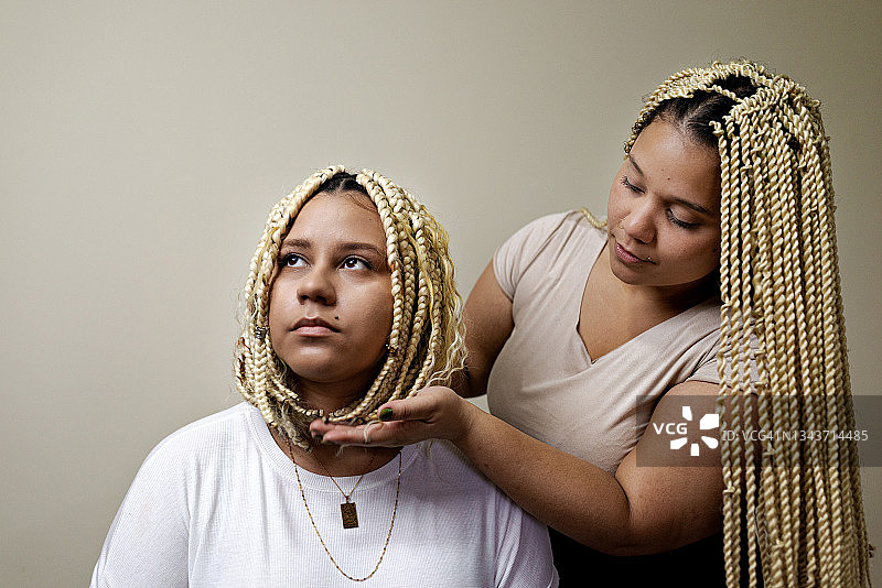 年轻女人梳非洲辫打理头发图片素材